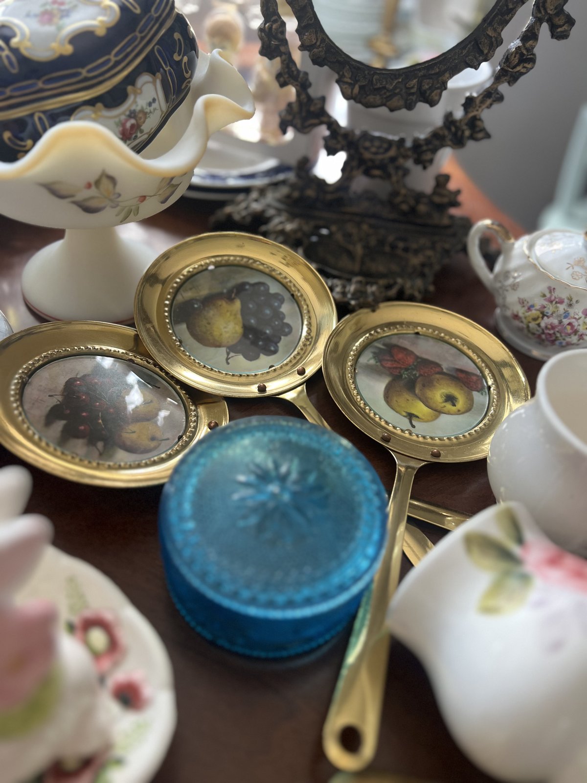 A curated shelf of vintage porcelain and glass