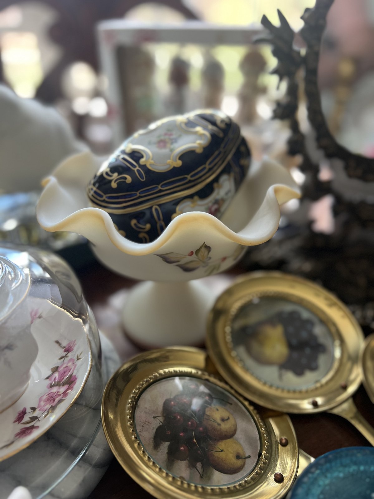 A curated shelf of vintage porcelain and glass