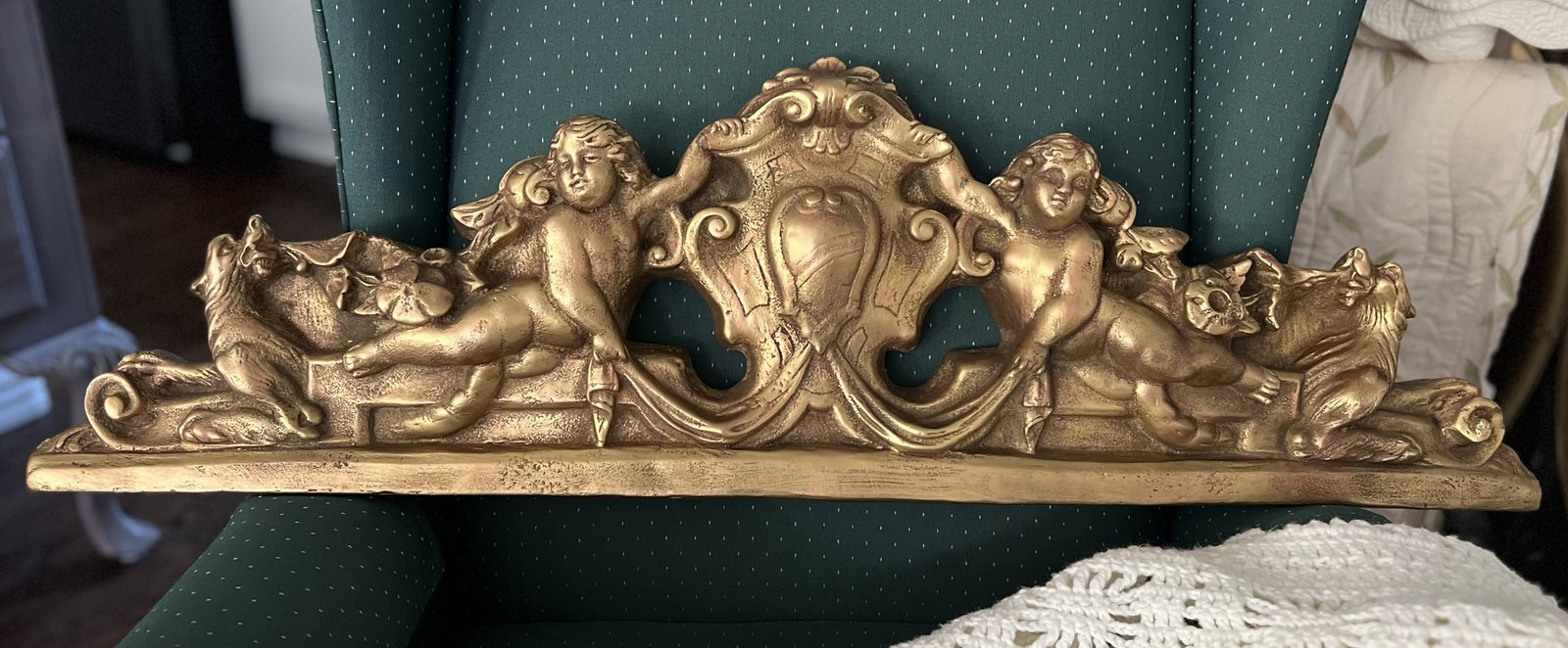 Ornate gold gesso wall pediment with cherub and lion details