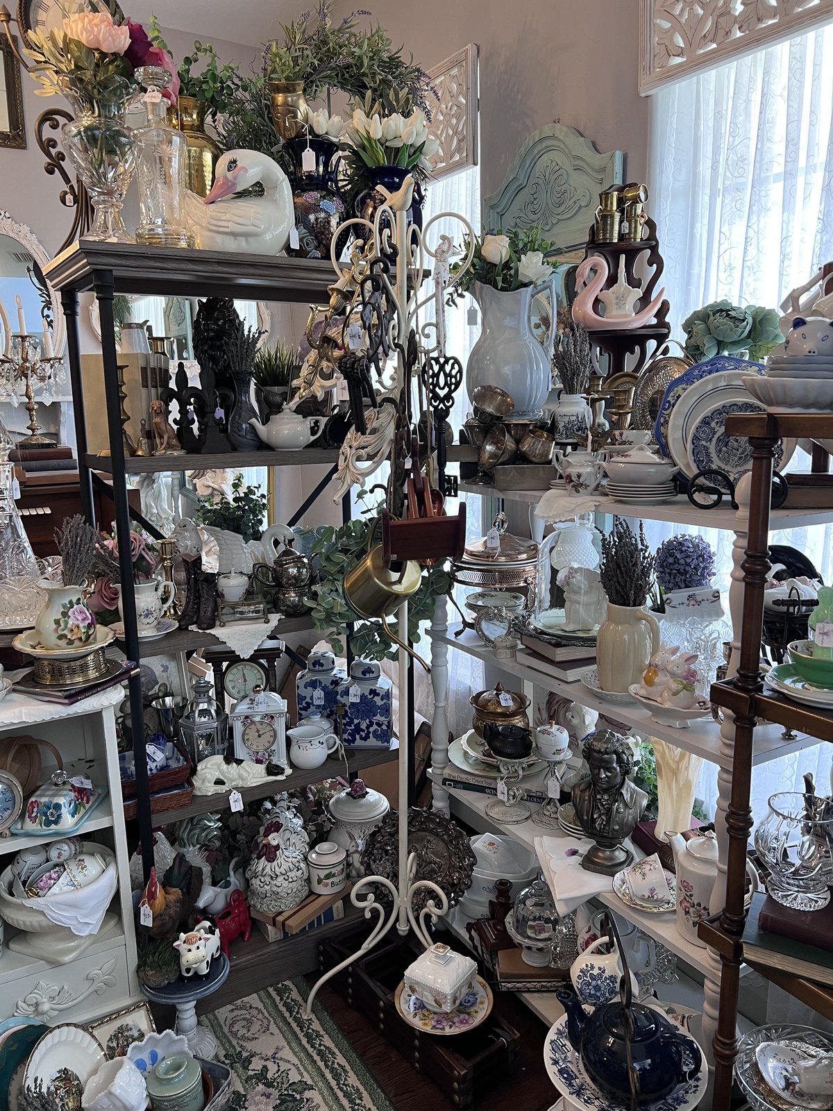A curated etagere of vintage glass and china