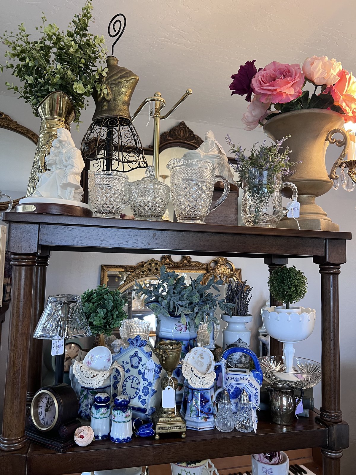 A curated shelf of vintage teapots and china