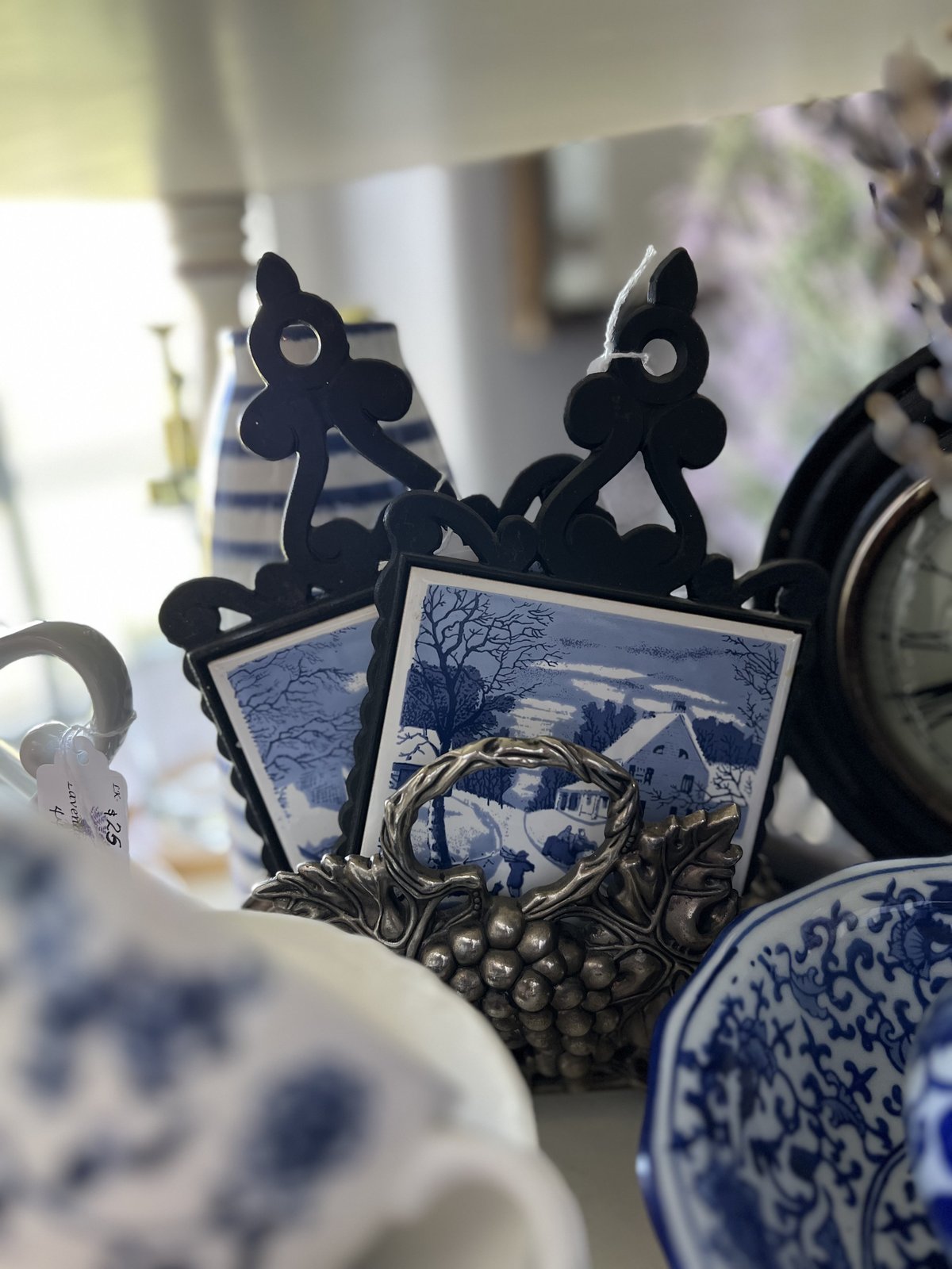 Blue and white winter cottage scene tile trivets in a silver grape-motif stand